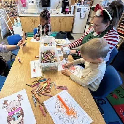 Students coloring with the principals